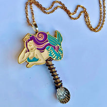 Magic Mermaid Necklace with a mermaid charm centerpiece and matching wiring detail on a shell shaped spoon pendant.