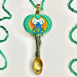 Custom Sacred Scarab Festival Spoon Pendant Necklace with a symbolic Egyptian Scarab beetle centerpiece charm with matching wire wrapping details on a large scoop size gold spoon base and a matching turquoise necklace chain.