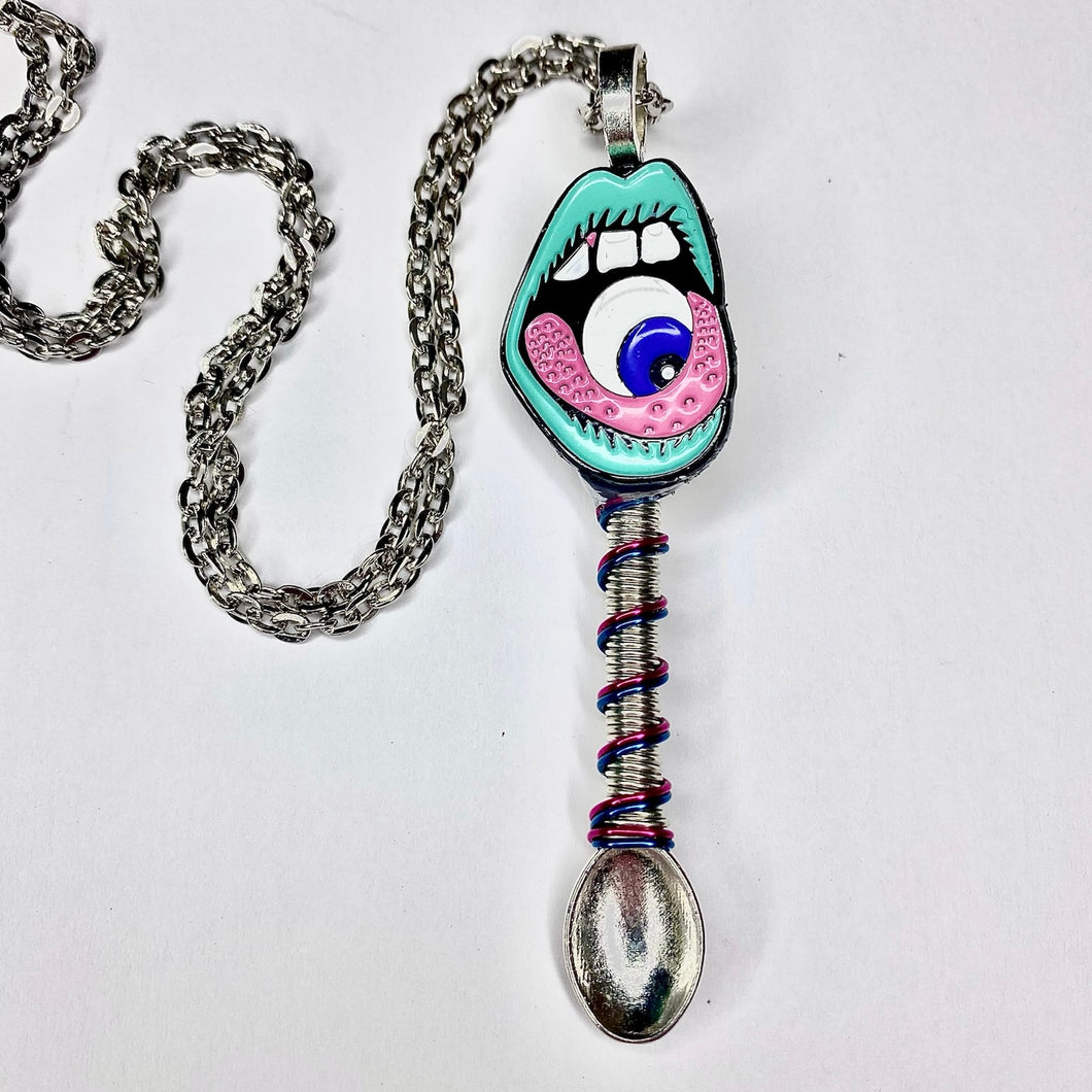 Custom Festival Tiny Sesh Spoon Necklace with an alien evil eye centerpiece charm with complimenting wire wrapped accents on a large scoop size silver spoon pendant base.