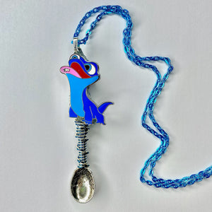 Custom Tiny Festival Spoon Pendant Necklace featuring a blue lizard catching a snowflake on it's tongue as a centerpiece charm with matching wire wrapping details on a large scoop size silver spoon base with a light blue necklace chain.